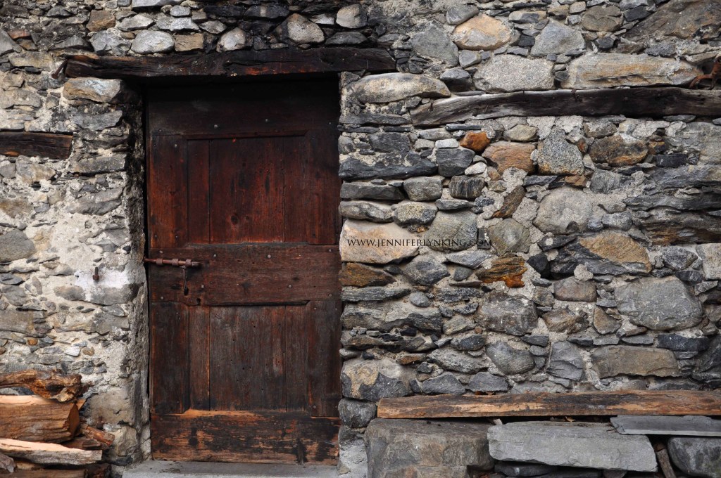 Stone village, chestnut door, Italian Alps